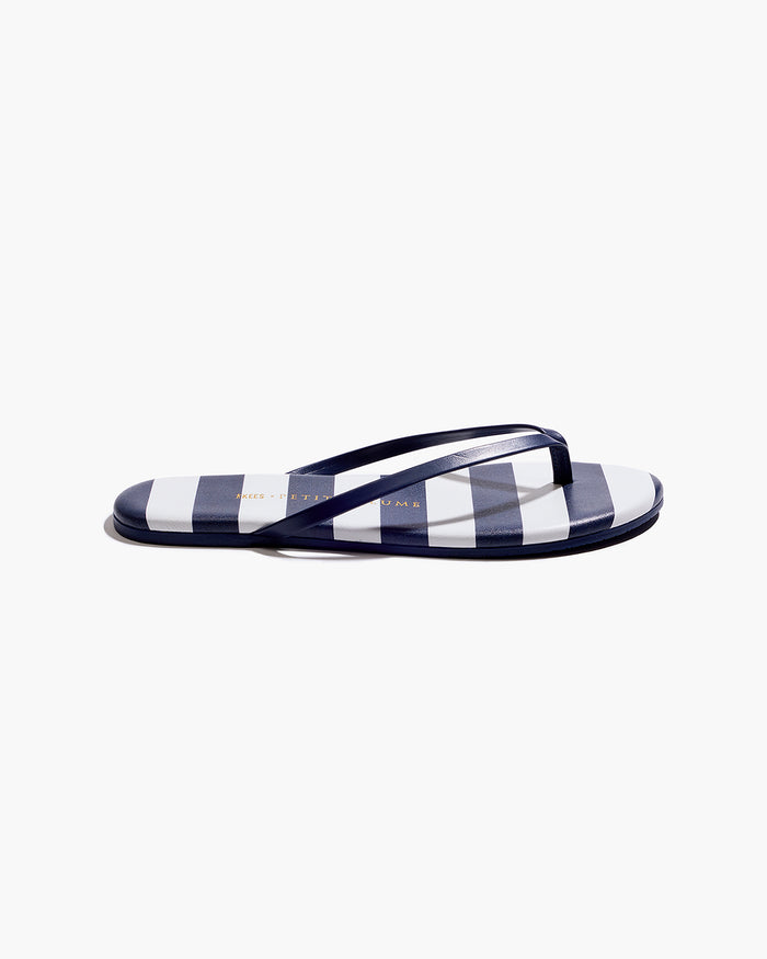 The Petite Plume x TKEES Lily Sandal in Cabana Stripe features navy blue and white horizontal stripes on the footbed with navy straps, shown side by side on a white background.