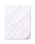 The Petite Plume Pima Baby Blanket in Blushing Bows is crafted from luxurious Peruvian Pima Cotton and features a charming pattern of small pink ballet dancers and bows. Its neatly folded design with visible rounded corners brings elegance to any nursery.