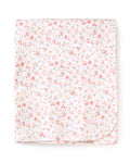 The Pima Baby Blanket in Dorset Floral by Petite Plume is crafted from folded Peruvian Pima Cotton with a delicate pink floral pattern, showcasing small flowers and thin green stems. It makes for a luxurious baby blanket.