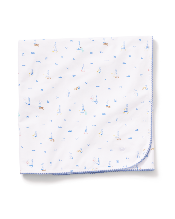 The Pima Baby Blanket in Letters and Lullabies features a folded white design with a blue stitched edge, adorned with small, colorful animal and letter prints scattered across the fabric.