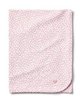 The Petite Plume Pima Baby Blanket in Sweethearts is a soft, white blanket made from luxurious Peruvian Pima Cotton. It features a pattern of small pink hearts, and a subtle outline of a small animal in one corner, adding both comfort and charm for your little one.