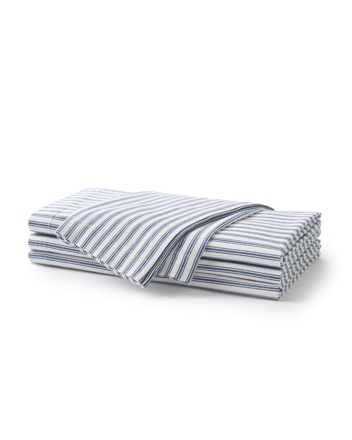 Folded blue and white striped fabric on a white background