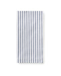 A set table with navy blue and white striped napkins, placed on a plate, with a decorative napkin ring, surrounded by cutlery and a patterned tablecloth in the background.