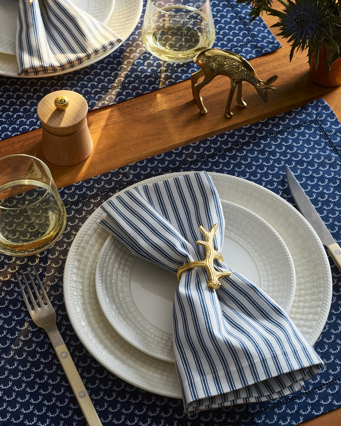 Folded blue and white striped fabric on a white background