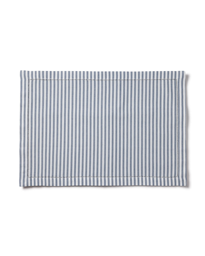 The Signature Twill Placemat in Navy French Ticking features vertical blue and white stripes with a stitched border, displayed flat against a white background.