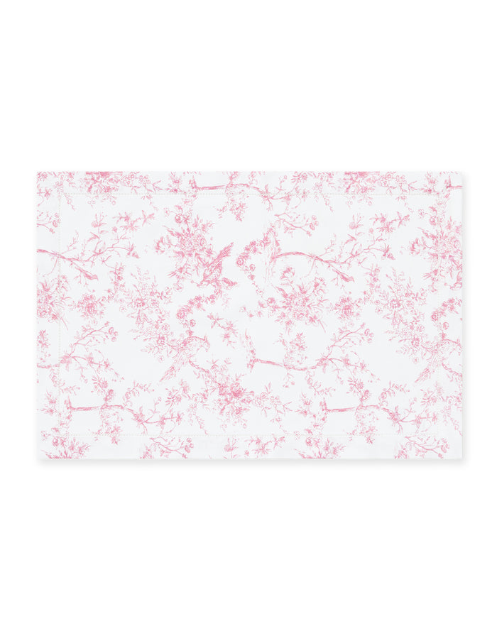 Signature Twill Placemats in Pink Timeless Toile feature a rectangular white cloth with a delicate pink floral and bird toile pattern.