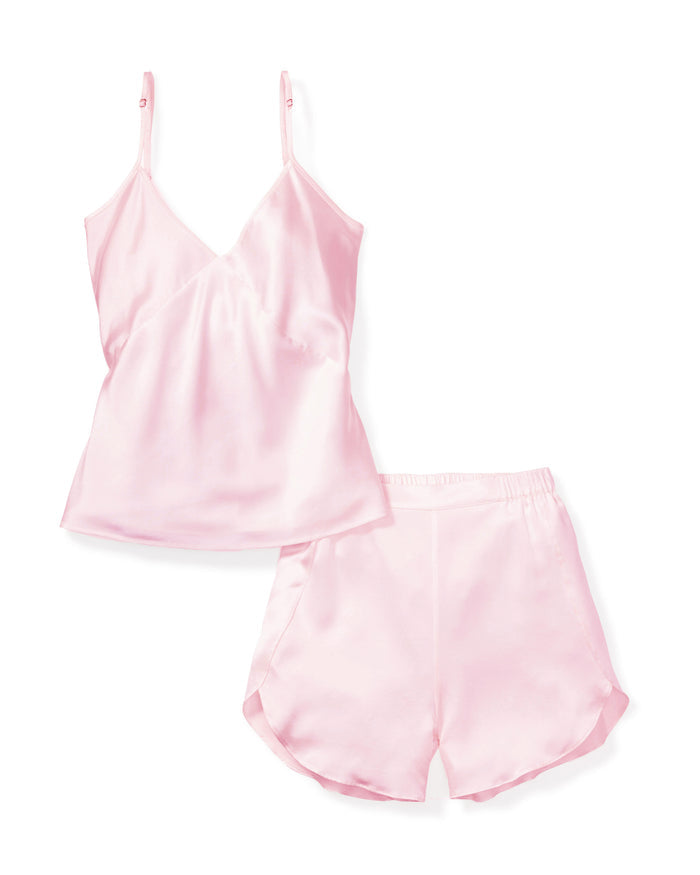The Womens Silk Cami Short Set in Pink by Petite Plume features a sleeveless top with spaghetti straps and V-neck, paired with comfortable, loose-fitting shorts. The sets elastic waistband adds comfort to the luxurious silk sleepwear, beautifully displayed on a white background.