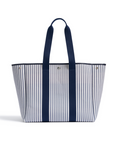 The Beckett Canvas Tote Bag in Navy French Ticking is a spacious tote with vertical blue and white stripes, two long navy handles, and a structured, open-top design.