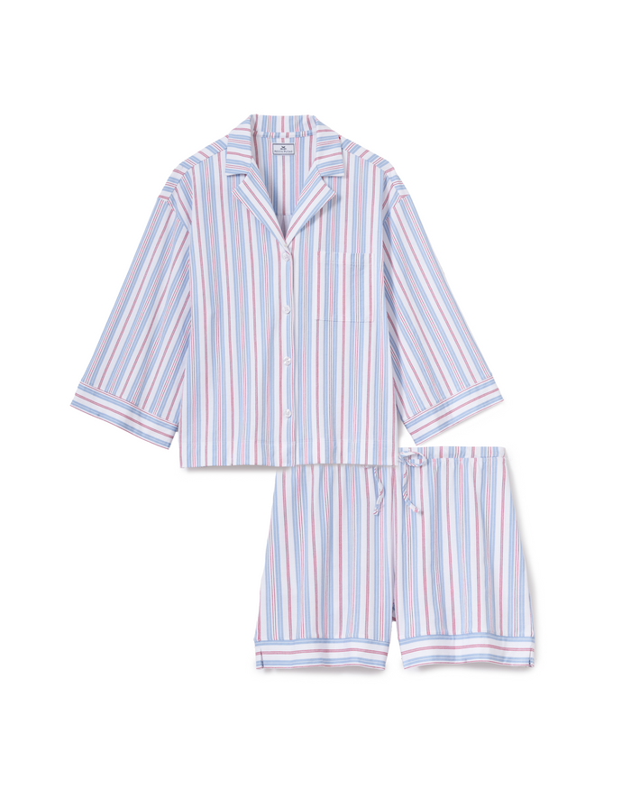 The Olivia Lightweight Pima Short Set in Vintage French Stripes features a button-up, short-sleeve top with a collar and matching shorts, adorned with vertical stripes in light blue, white, and red.