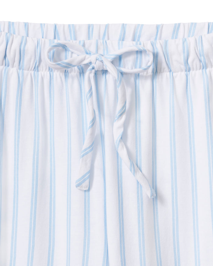 The Olivia Pima Short Set in Periwinkle Stripe features light blue and white vertical stripes, a short-sleeve button-up shirt with a chest pocket, and matching drawstring shorts.