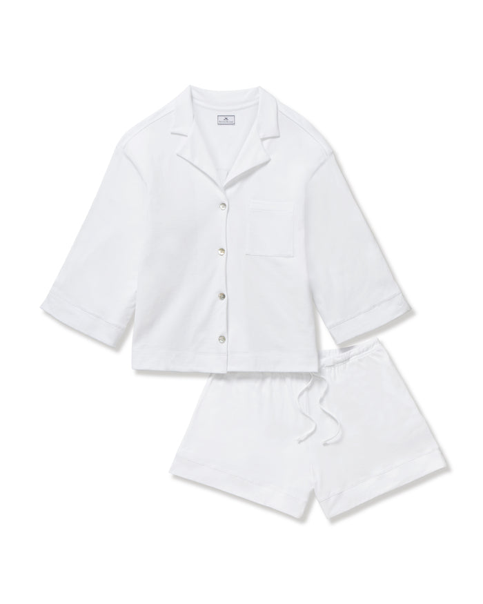 The Olivia Pima Short Set in White features a matching pajama set with a button-up, collared shirt with a chest pocket and three-quarter sleeves, paired with elastic waist drawstring shorts.