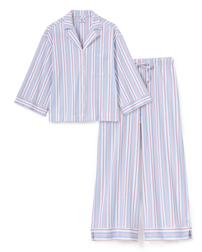 The Olivia Wide Leg Lightweight Pima Pajama Set in Vintage French Stripes features a coordinating button-up, long-sleeve top and relaxed wide-leg pants, both adorned with vertical stripes in blue, red, and white.