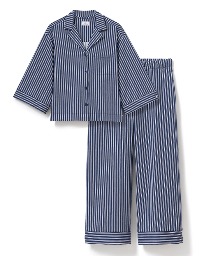 The Olivia Wide Leg Pima Pajama Set in Admiral Ticking features a blue and white vertical striped design, including a button-up long-sleeve shirt with a collar and chest pocket, plus matching elastic-waist wide-leg pants—both finished with stylish cuff details.