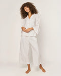 The Olivia Wide Leg Pima Pajama Set in Camel Ticking features light-colored, long-sleeve striped pajamas with brown buttons and matching drawstring pants, displayed flat on a white background.
