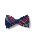 The Windsor Tartan dog bow tie by Petite Plume showcases festive, colorful red, green, and blue plaid patterns with a small white PETITE label on one side.