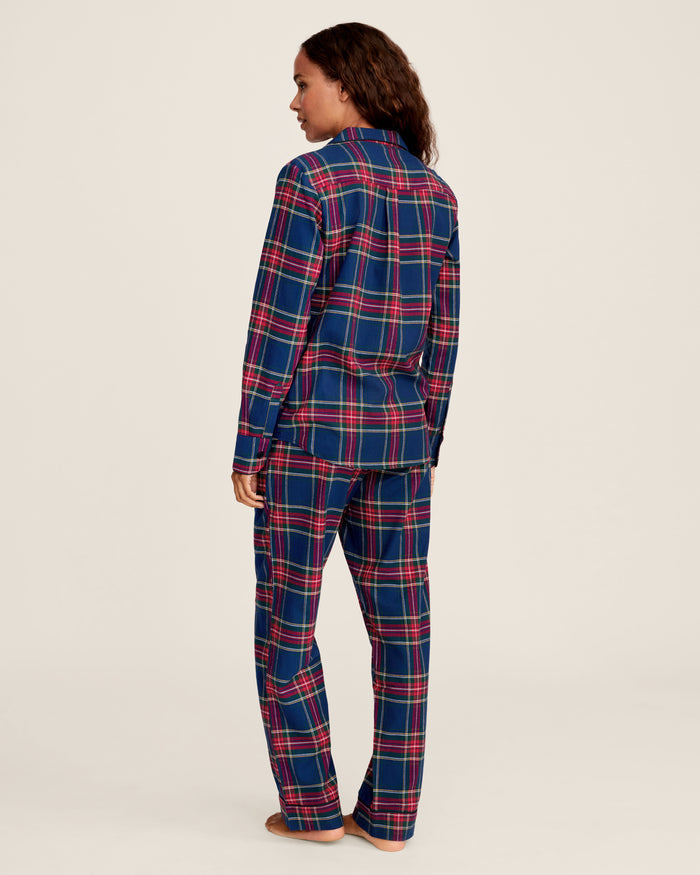 Close-up of Windsor Tartan fabric with red, green, and white stripes on navy by Petite Plume. The soft, brushed cotton texture resembles a classic pajama set with a button and lapel for added coziness.