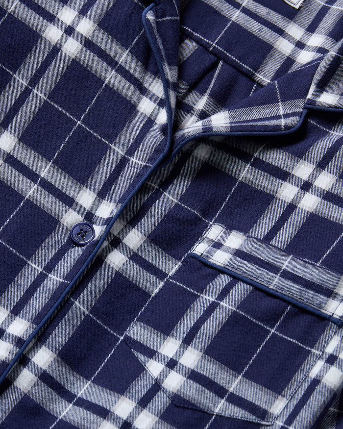 The Women's Brushed Twill Short Sleeve Short Set in Oxford Tartan features a navy and white plaid pattern, a short-sleeve button-up shirt with chest pocket, and drawstring shorts—perfect for a coordinated pajama look.