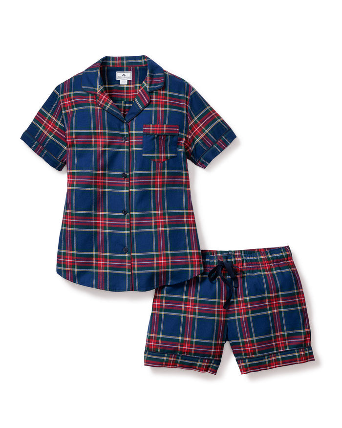 A close-up of Petite Plumes Womens Brushed Cotton Short Sleeve Short Set in Windsor Tartan showcases a blue, red, and green plaid fabric with a button emblem and contrasting piping on the pocket, epitomizing the elegance of luxury cotton sleepwear.