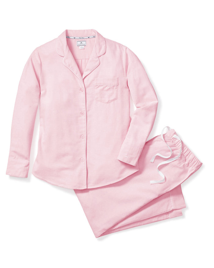 The Petite Plume Womens Flannel Pajama Set in Pink offers luxurious comfort with a long-sleeve button-up top featuring a chest pocket and collar. Made from premium cotton, the pants have an elastic waistband and white drawstring for ultimate ease.