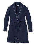 The Womens Flannel Robe in Navy by Petite Plume features a moisture-wicking weave with white piping, two front pockets, and a belt tie for comfort and style. Its elegantly displayed flat against a white background.