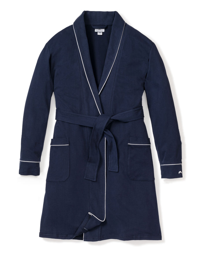 The Womens Flannel Robe in Navy by Petite Plume features a moisture-wicking weave with white piping, two front pockets, and a belt tie for comfort and style. Its elegantly displayed flat against a white background.