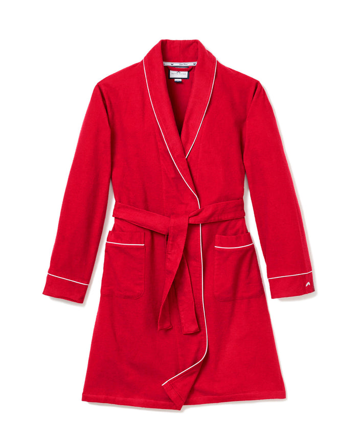 The Womens Flannel Robe in Red with White Piping by Petite Plume features two front pockets and a matching belt, ideal for monogramming. The robe is displayed against a plain white background.