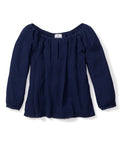 The Womens Gauze Willow Scoopneck Top in Navy by Petite Plume, from our Gauze Collection, is crafted from a textured cotton gauze fabric. Its off-the-shoulder design and flowy silhouette offer an elegant luxury loungewear option.