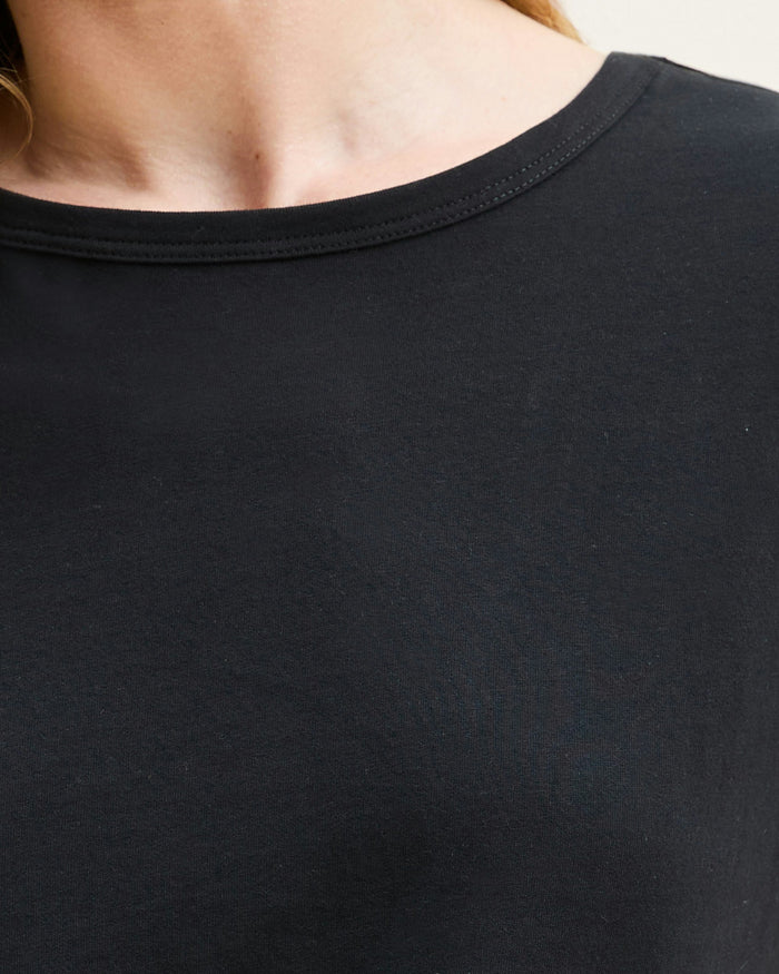 A black crew neck t-shirt made from pima cotton, displayed against a white background.