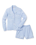 The Petite Plume Womens Pima Pajama Short Set in Periwinkle features a long-sleeve button-up top with a chest pocket and white piping, paired with matching shorts accented by white piping along the hem. Made from luxurious Peruvian Pima cotton, these classic PJs ensure comfort and style.