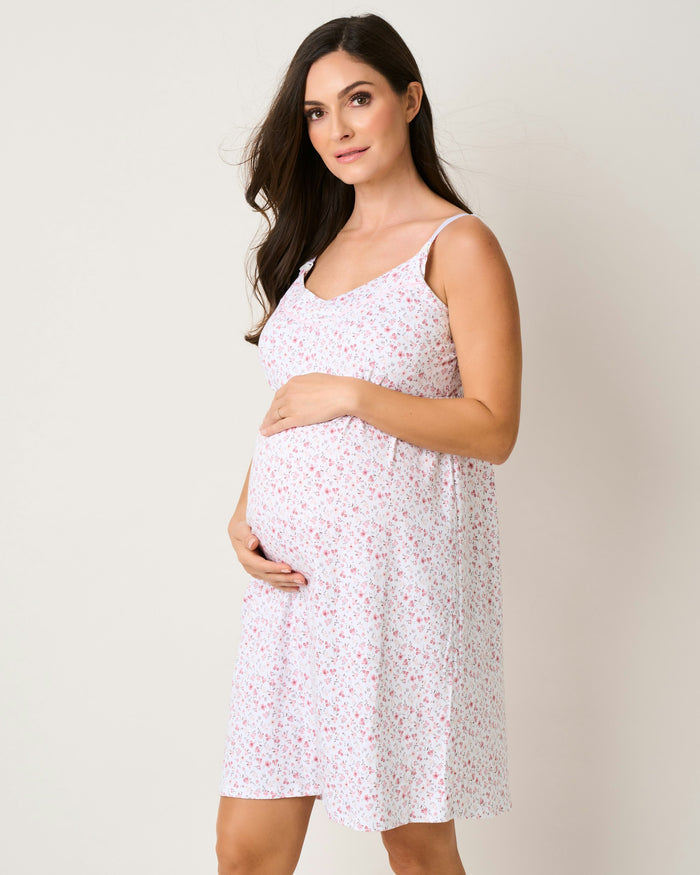 A pink floral maternity nightgown with thin straps and a flowing silhouette.