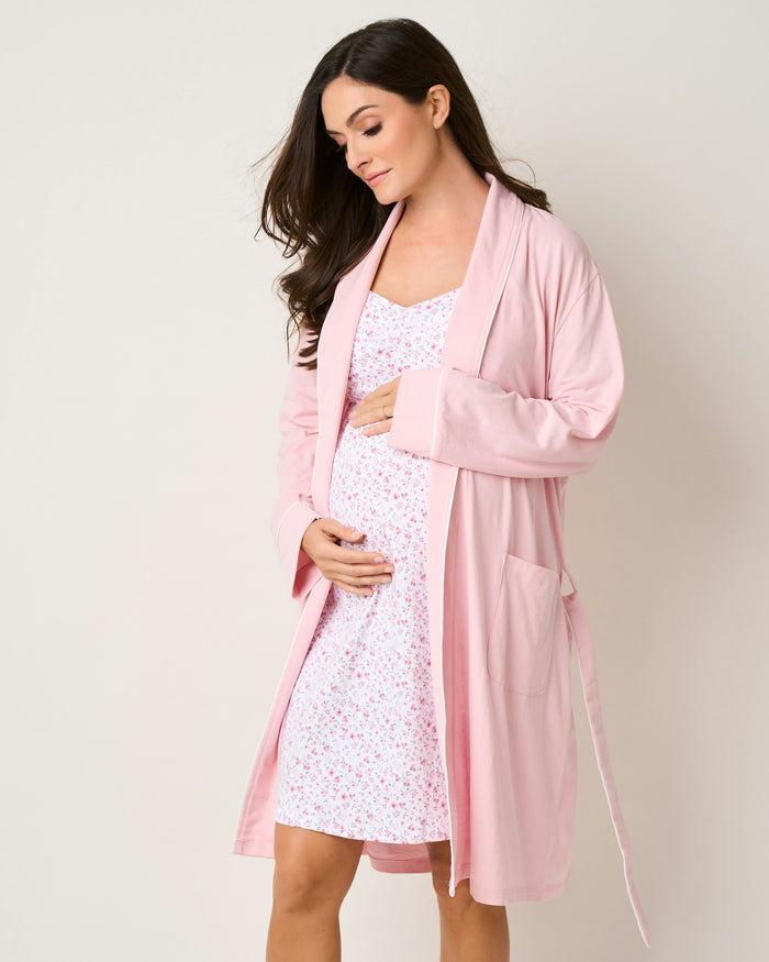 A pink floral maternity nightgown with thin straps and a flowing silhouette.