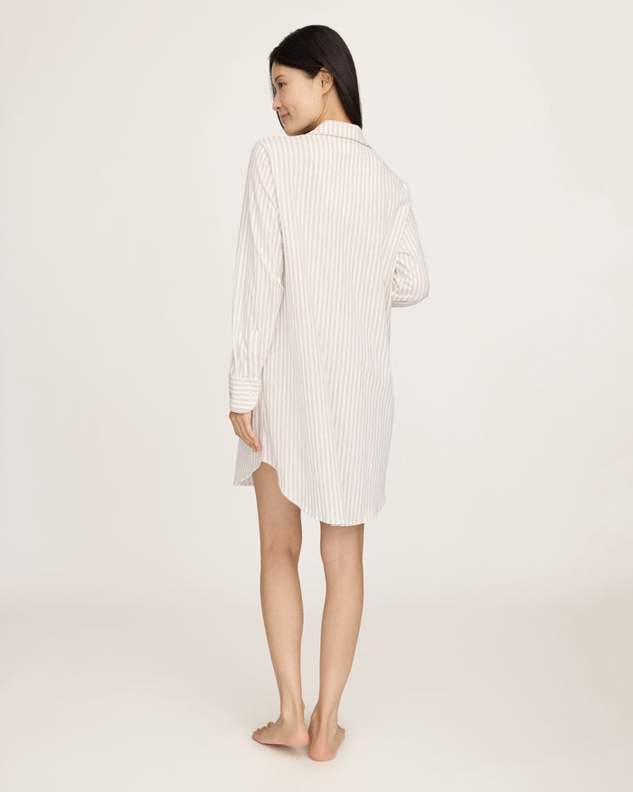 The Women's Pima Maternity Nightshirt in Camel Ticking features beige and white vertical stripes, long sleeves with cuffs, a collar, chest pocket, and partial button placket, and falls to knee length.