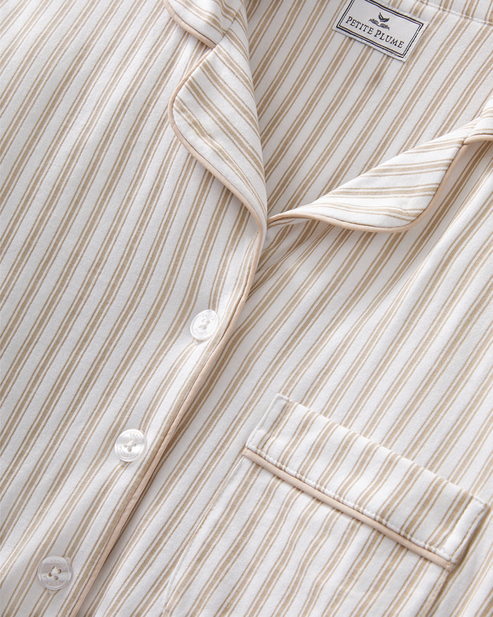 The Women's Pima Maternity Nightshirt in Camel Ticking features beige and white vertical stripes, long sleeves with cuffs, a collar, chest pocket, and partial button placket, and falls to knee length.