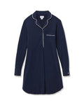 The Women's Pima Maternity Nightshirt in Navy features long sleeves, white piping on the collar, pocket, and cuffs, a chest pocket, button v-neckline, and a relaxed fit.