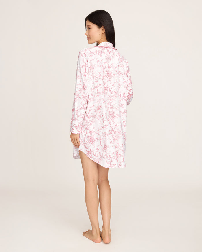 The Women's Pima Maternity Nightshirt in Pink Timeless Toile features long sleeves, a button-up front, a chest pocket, and a relaxed fit with a pink floral toile pattern on white.