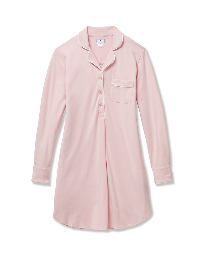 The Women's Pima Maternity Nightshirt in Pink features long sleeves, white piping, a collar, front buttons, single chest pocket, and a curved hem in soft, comfortable fabric.