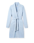 The Petite Plume Womens Pima Maternity Robe in Periwinkle offers a shawl collar, long sleeves, and two front pockets. It features white piping along the edges, a matching fabric belt at the waist, and is crafted from soft pima cotton for comfort and elegance.