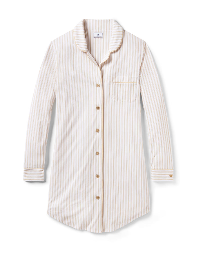The Women's Pima Nightshirt in Camel Ticking features beige and white vertical stripes, long sleeves, a knee-length cut, button-down front, chest pocket, and collar; shown laid flat on a white background.