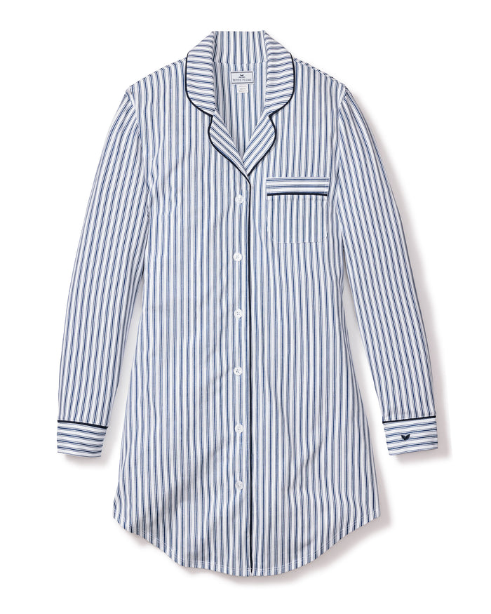 Enjoy the Petite Plume Womens Pima Nightshirt in Navy French Ticking, a long-sleeved blue-and-white striped nightshirt made from luxurious Pima cotton. It features a collar, button-down front, chest pocket with matching stripes, and dark borders on the cuffs for an elegant touch.