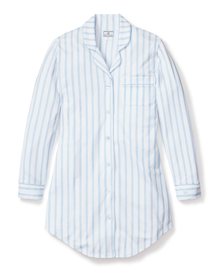 The Womens Pima Nightshirt in Periwinkle and White Stripe by Petite Plume features long sleeves, a button-up front, chest pocket, and collar, crafted from soft Peruvian Pima cotton—luxurious pajamas shown laid flat on a white background.
