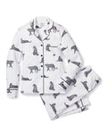 The Petite Plume Womens Pima Pajama Set in Panthère de Paris features a white, long-sleeve button-up top and pants made of Peruvian Pima cotton, adorned with elegant black leopard sketches and detailed with black piping on the collar and pockets.