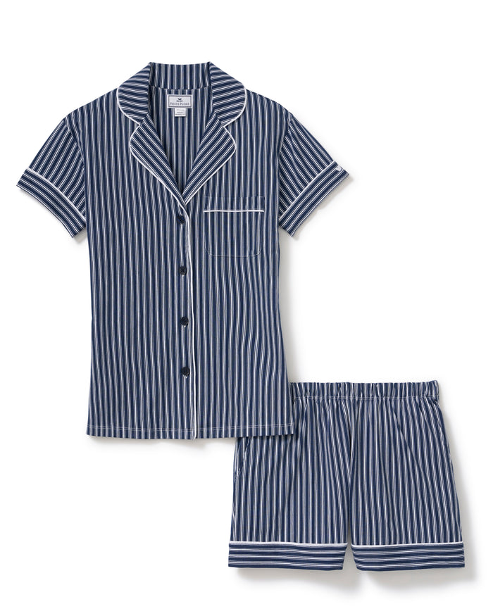Women’s Pima Short Sleeve Short Set in Admiral Ticking features a navy and white vertically striped button-up pajama top with a chest pocket, paired with matching elastic-waist shorts.
