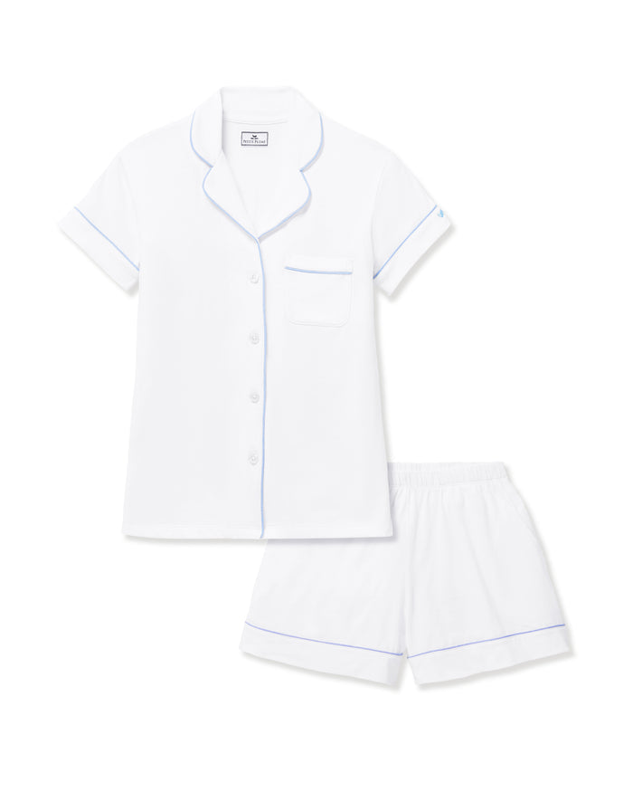 The Women's Pima Short Sleeve Short Set in White with Periwinkle Piping includes a collared button-up top with a chest pocket and matching shorts featuring an elastic waistband.