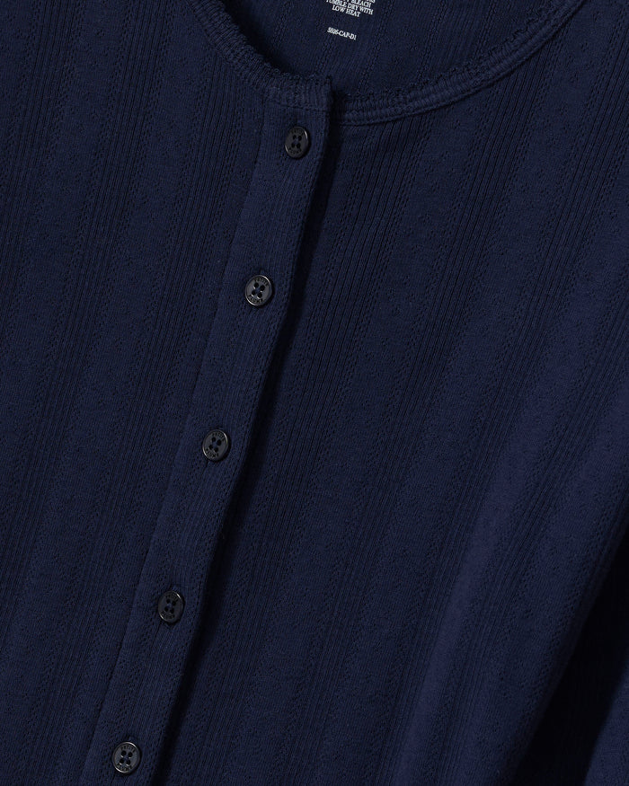 Close-up of the Women’s Pointelle Cardigan in Navy, featuring a textured design with vertical ribbed patterns and six black buttons along the front placket.