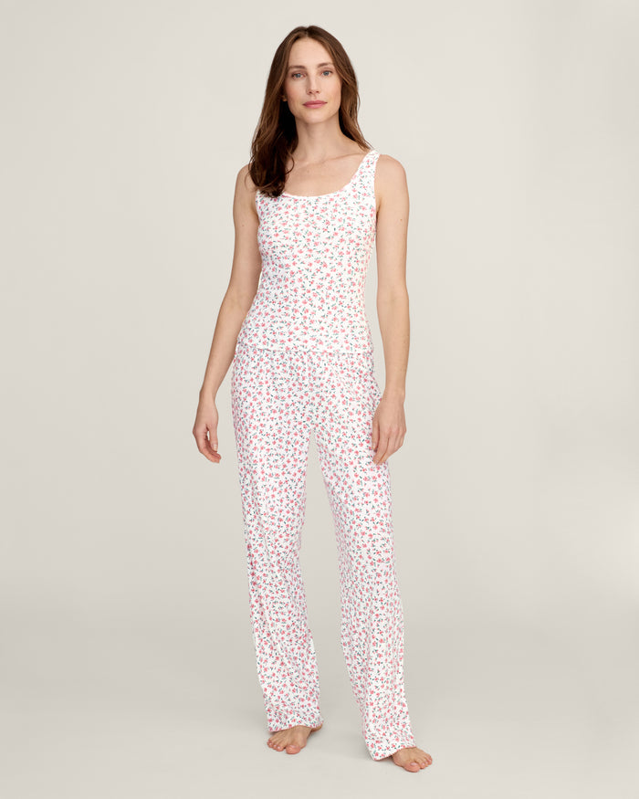 A woman stands barefoot against a plain background, wearing the Women's Pointelle Pant in Pink Floral.