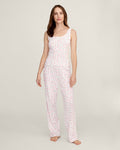 A woman stands barefoot against a plain background, wearing the Women's Pointelle Pant in Pink Floral.