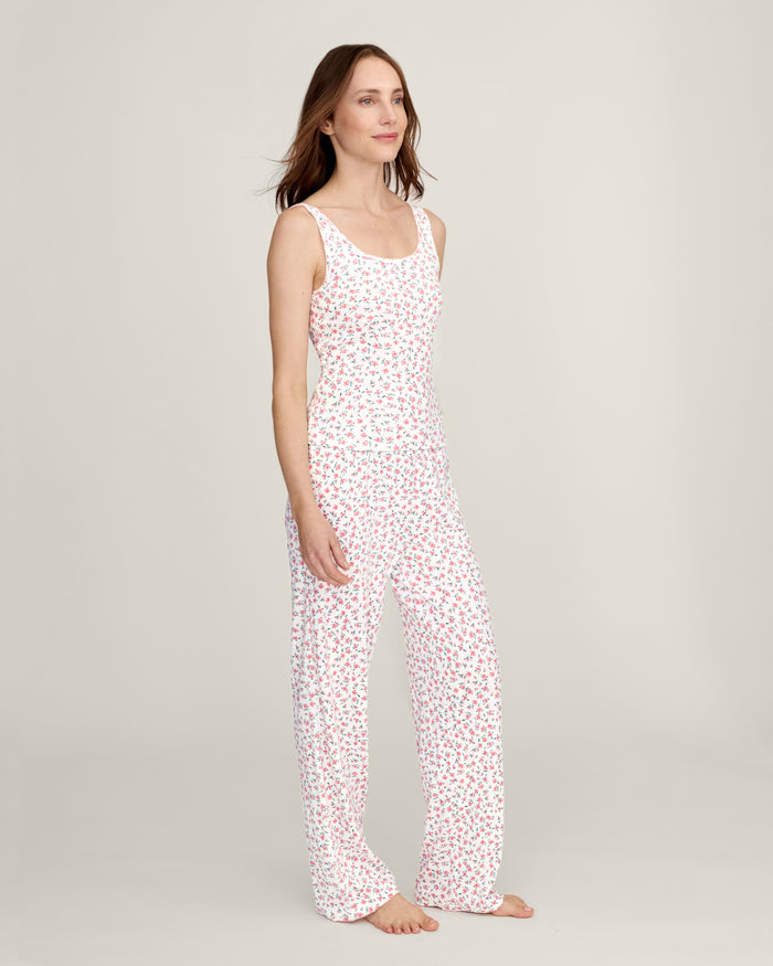A woman stands barefoot against a plain background, wearing the Women's Pointelle Pant in Pink Floral.