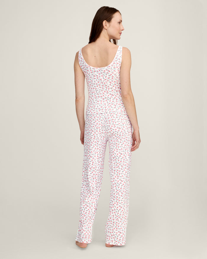 A woman stands barefoot against a plain background, wearing the Women's Pointelle Pant in Pink Floral.