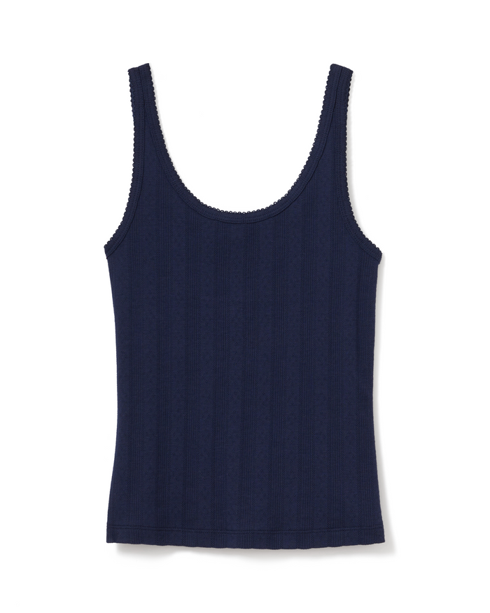 The Women’s Pointelle Tank in Navy is a sleeveless, ribbed top featuring a scoop neckline and subtle scalloped trim along the edges.