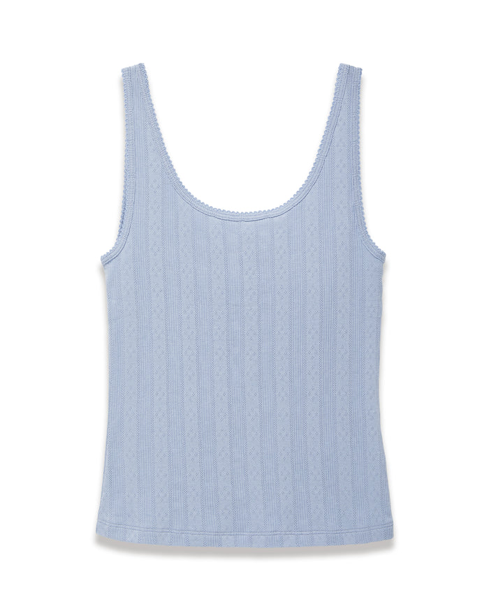 A woman with long wavy hair wears the Women's Pointelle Tank in Periwinkle, standing against a plain off-white background.